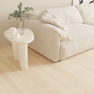 Cream white 8mm SPC flooring beside a sofa and side table